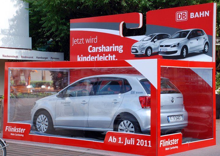 Silver Flinkster car in a large advertising package with the text 'Now carsharing is child's play' and 'From July 1, 2011'.